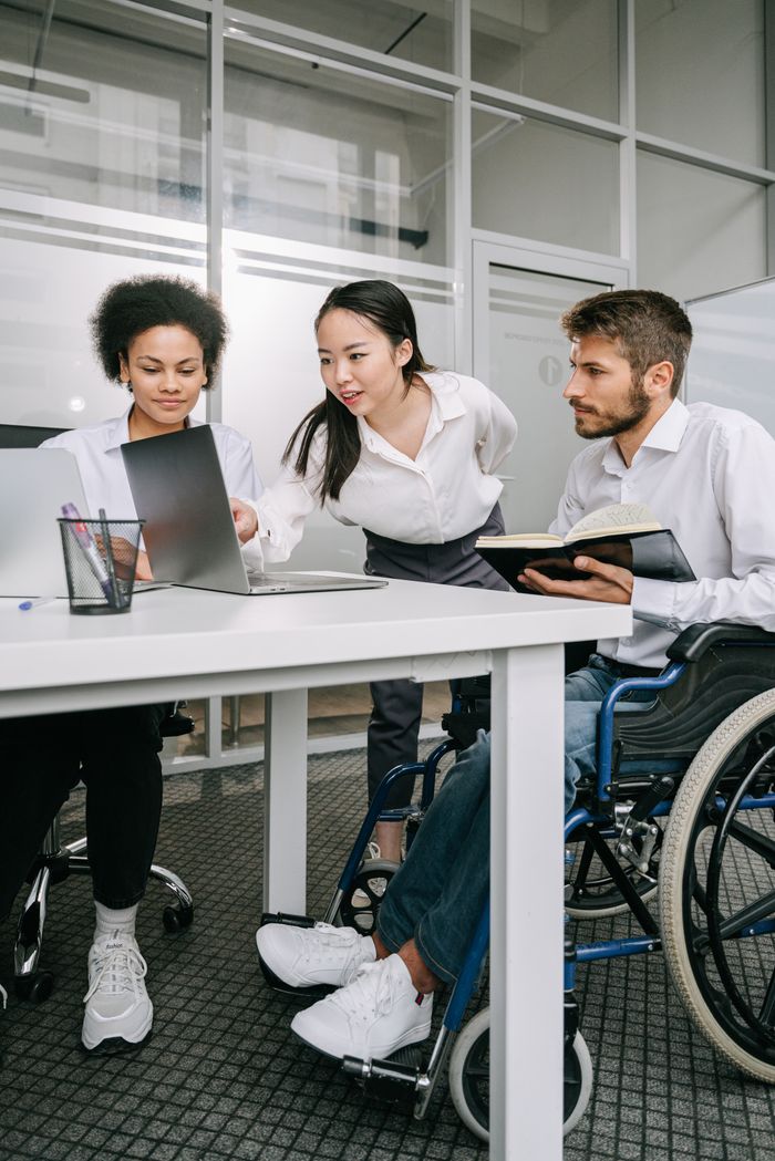 A diverse group of professionals engaged in a collaborative meeting in a contemporary office environment.